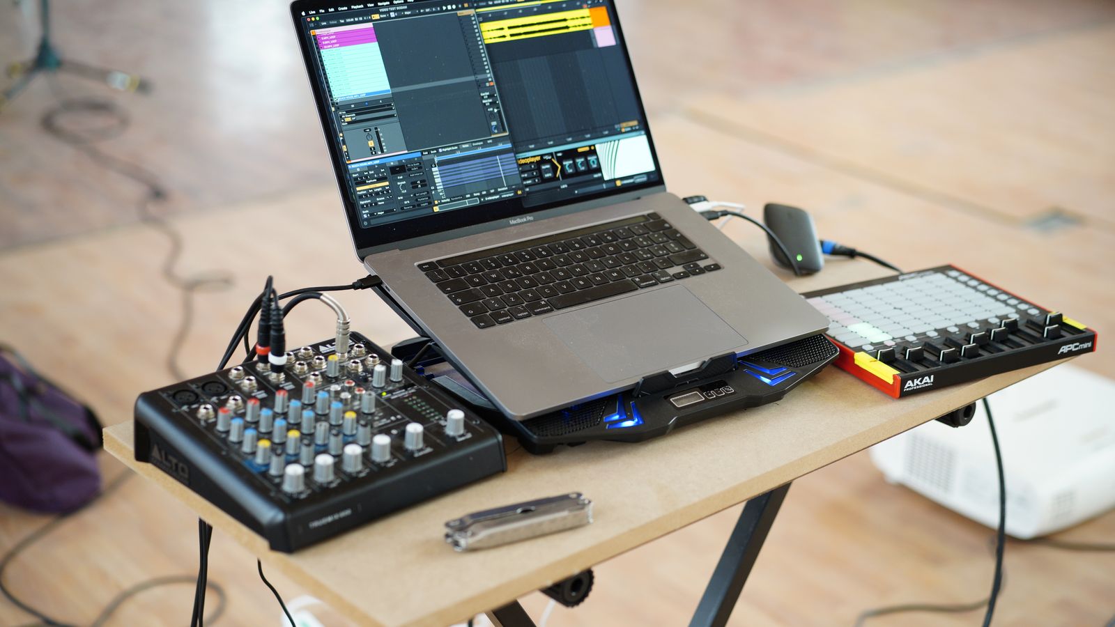 lived-in home-studio desk at the start of a session — one synth, open DAW on screen, coffee, half-finished idea
